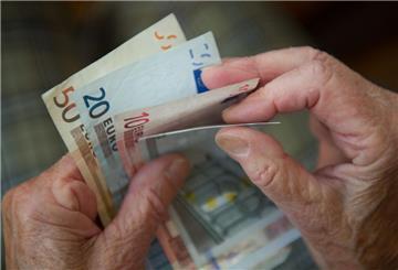 Ein Pensionär zählt Geldscheine.