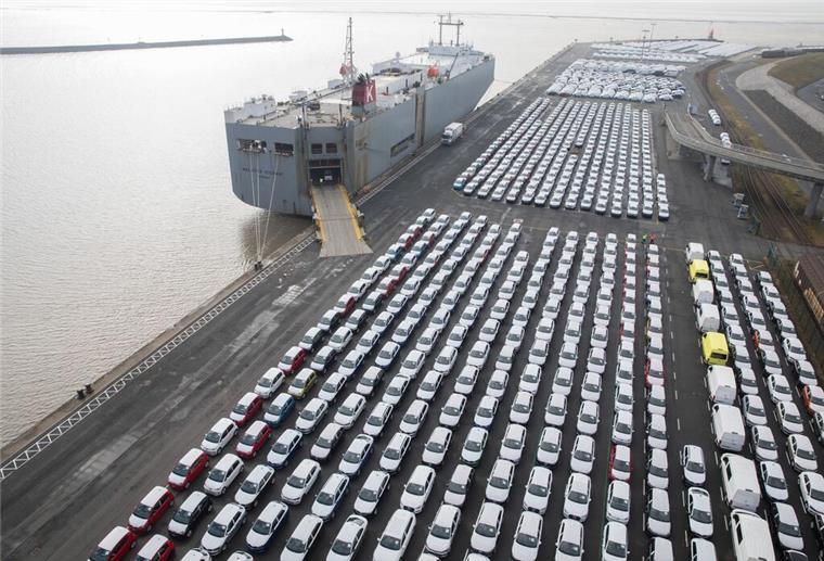 Zwischen Krabbenkuttern und Containerriesen: Urlaub an Niedersachsens Häfen Der Hafen in Emden mit Autoumschlag. Zu sehen sind viele Autos und ein großer Autofrachter an der Kaje.