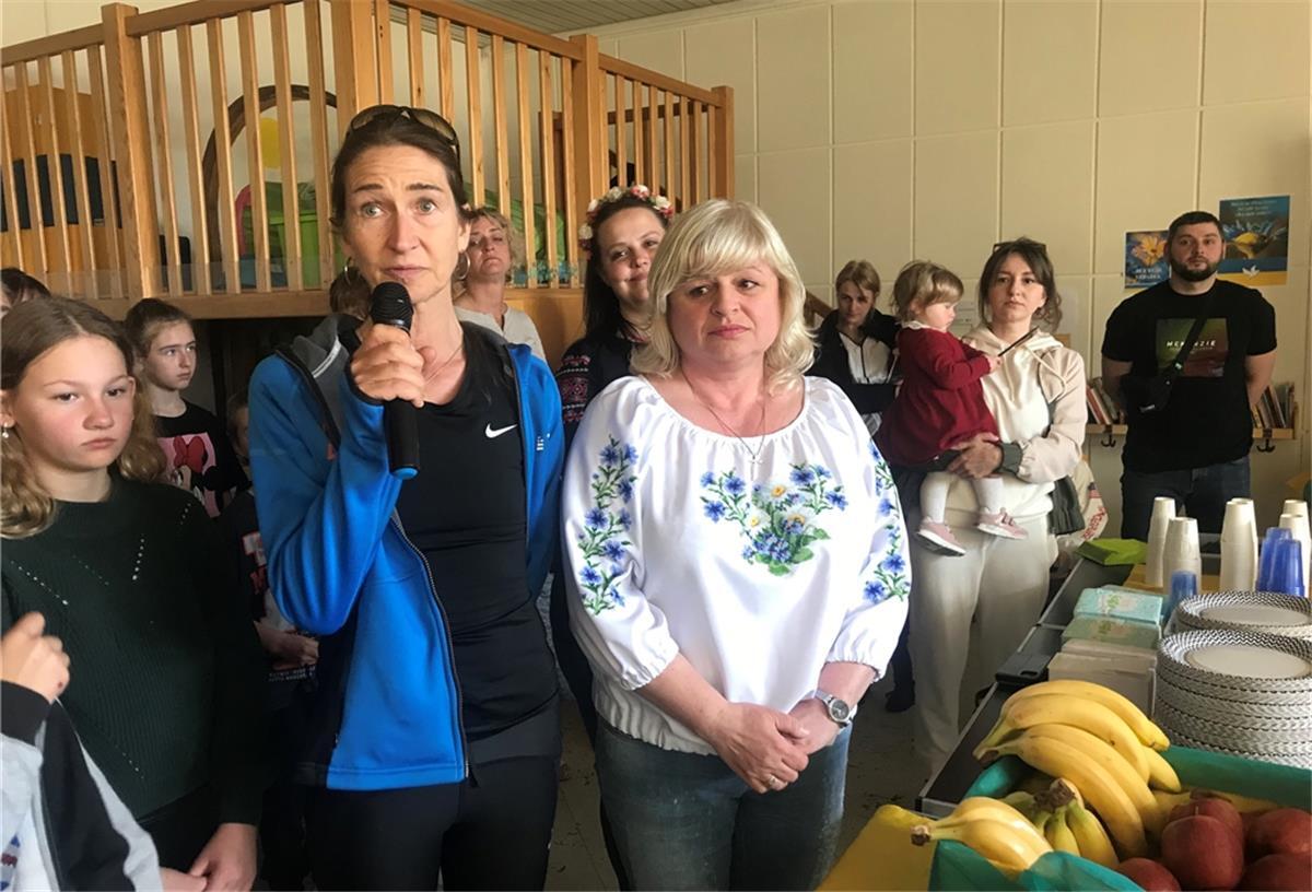 Tanja Lischewski von den Plaatweg Runners ergreift bei der Feier des orthodoxen Osterfests das Wort. Neben ihr die Ukrainerin Iryna Geissl. Die Plaatweg Runners haben mit einem Spendenlauf geholfen, die Feier im Mehrgenerationenhaus zu finanzieren.