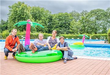 Menschen auf einer Badeinsel im Freibad Grünhöfe.