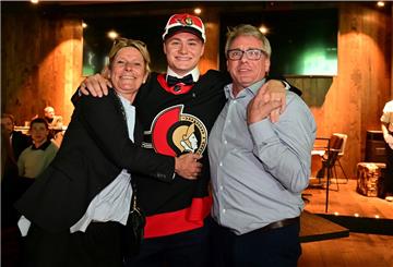 Tim Stützle von den Adler Mannheim mit seinen Eltern Marion und Martin.
