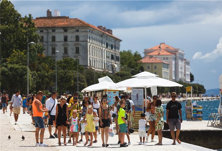 Teile Kroatiens als Corona-Risikogebiet eingestuft Touristen spazieren an einer kroatischen Uferpromenade entlang. Die Bundesregierung hat eine Corona-Reisewarnung für Teile des beliebten Reiselands an der Adria herausgegeben.
