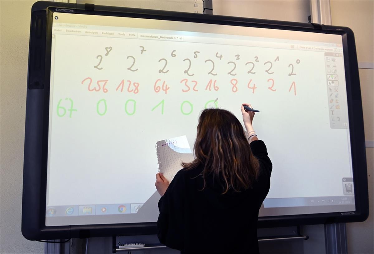 Eine Realschülerin einer zehnten Klasse arbeitet in einer Unterrichtsstunde an einem Active Board (interaktive Tafel).