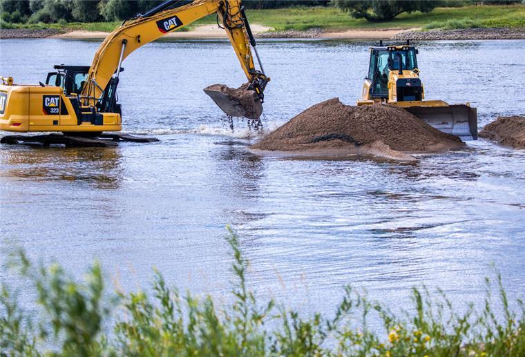 Auf einer Deichbaustelle für die Deichverstärkung am Hauke-Haien-Koog nahe des Fähranlegers Schlüttsiel wird mit schwerem Gerät die Deichkrone des alten Deiches erhöht. Der Bau der Klimadeiche in Schleswig-Holstein, die an steigende Meeresspiegel und höhere Sturmfluten angepasst sind, kommt voran. +++ dpa-Bildfunk +++