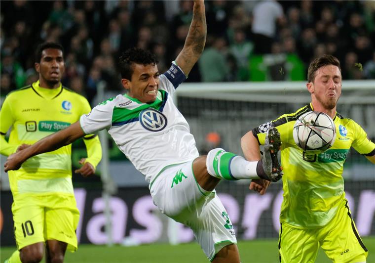 Voller Einsatz: Der Wolfsburger Luiz Gustavo (Mitte) im Zweikampf mit Gents Brecht Dejaegere. 