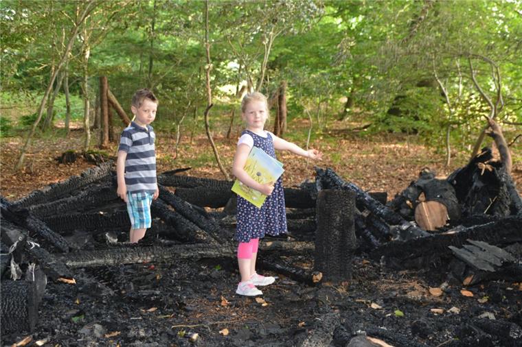 Lintiger Kinder sind traurig über Brand ihrer Hütte War der verkohlte Pfosten einmal ein Hocker oder ein Tisch? Janina und Junis gehen auf Spurensuche in der Asche. Ein Feuer hat den Ort zum Entdecken und Verweilen komplett zerstört.