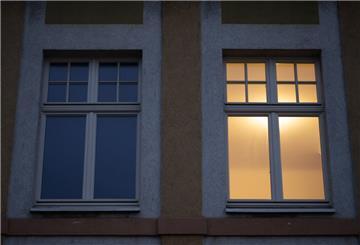  Ein Fenster in einer Wohnung ist beleuchtet. Viele Stromversorger erhöhen Preise. 